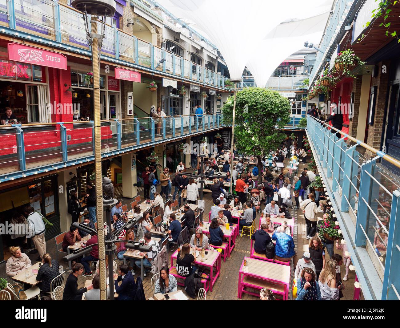 A view of people dining and enjoying food and drink in Kingly Court just off Carnaby Street in London UK Stock Photo