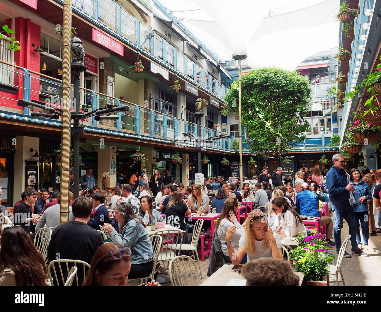 A view of people dining and enjoying food and drink in Kingly Court just off Carnaby Street in London UK Stock Photo