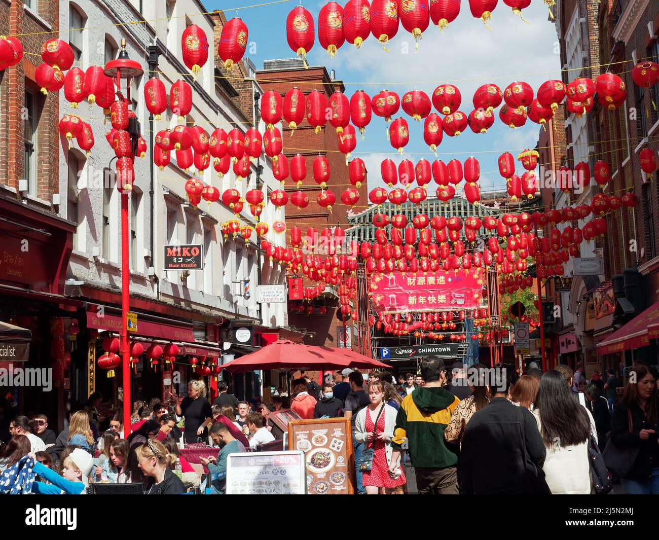 A view along Gerrard Street in London's Chinatown decorated with hanging red lanterns Stock Photo