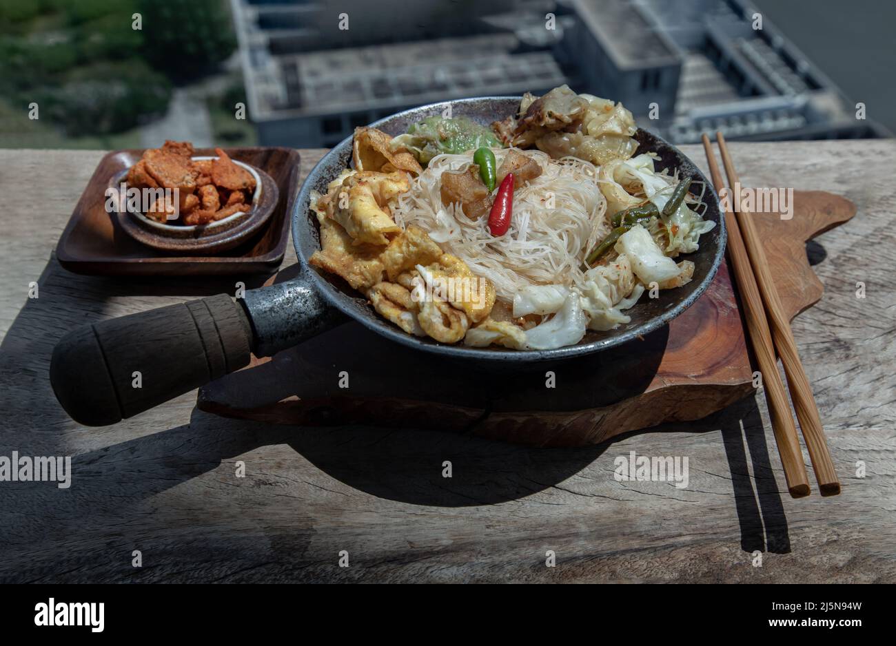 Stir fried rice vermicelli with pork dumplings, egg and vegetable in
