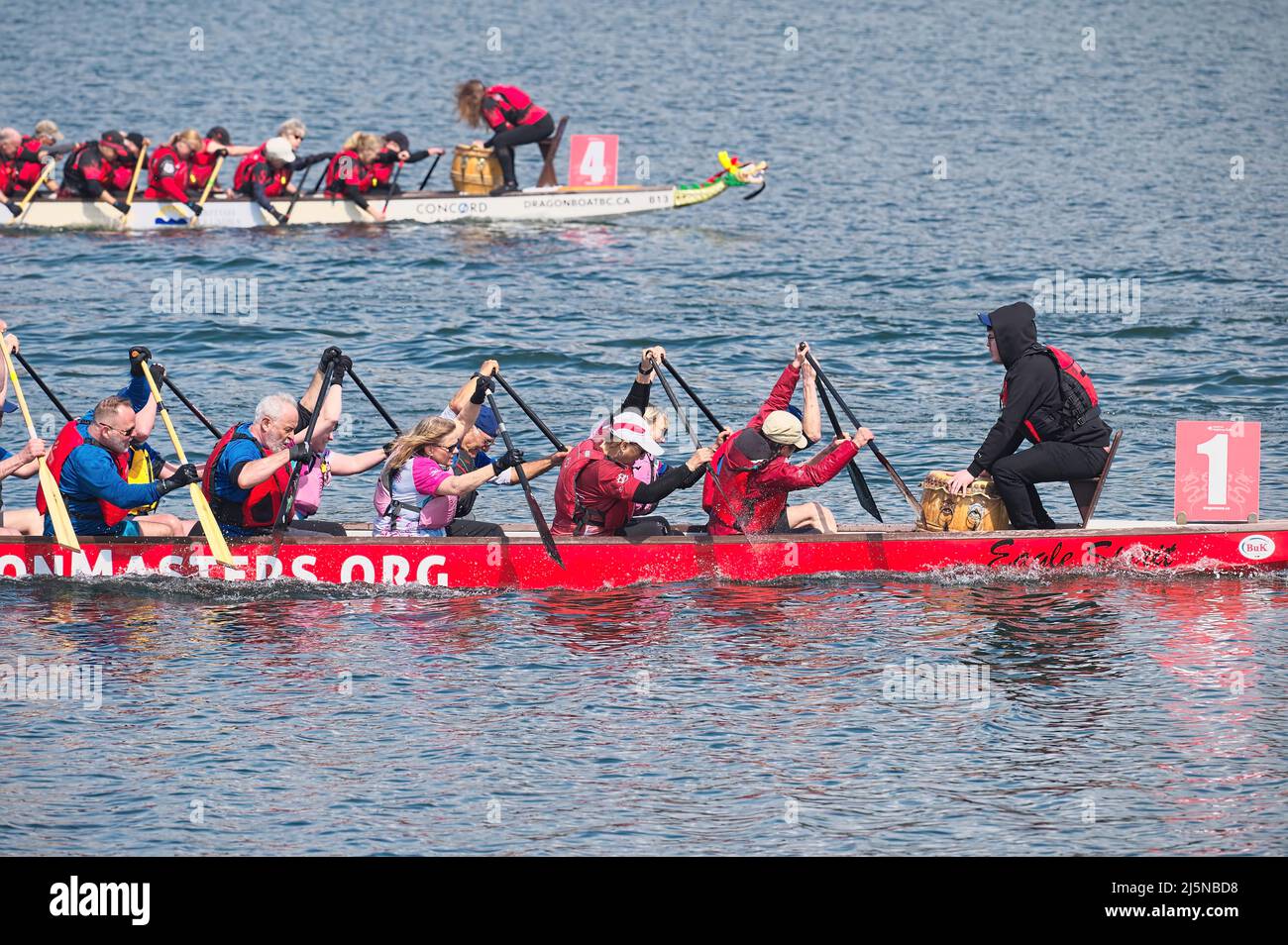 Competitors racing dragon boats in the Inlet Spring Regatta 2022 at Rocky Point Park, Port Moody, B. C., Canada. Stock Photo