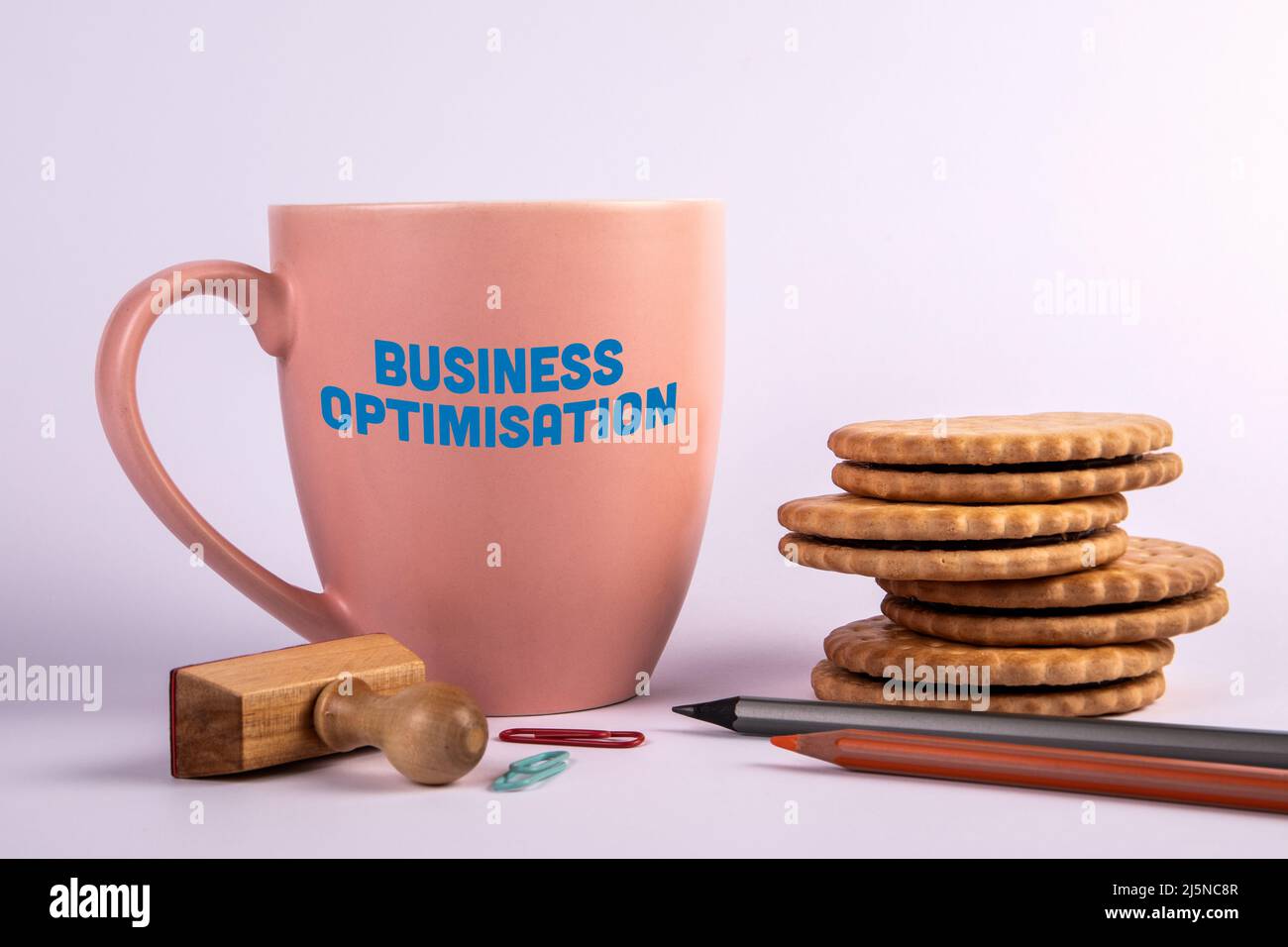 Business Optimisation concept. Coffee mug with text on a white background. Stock Photo