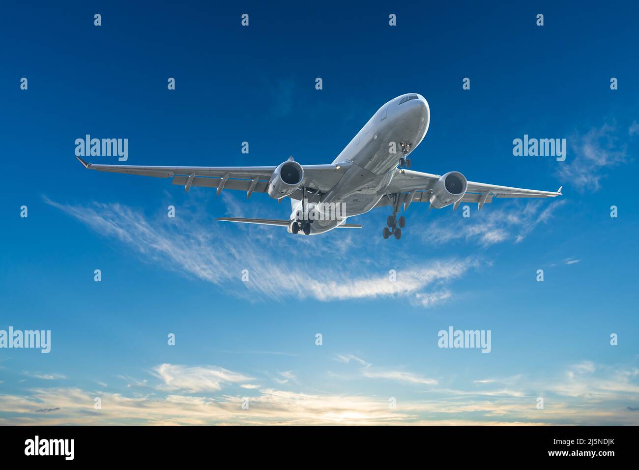 Airplane in the sunset sky. travel concept. Stock Photo