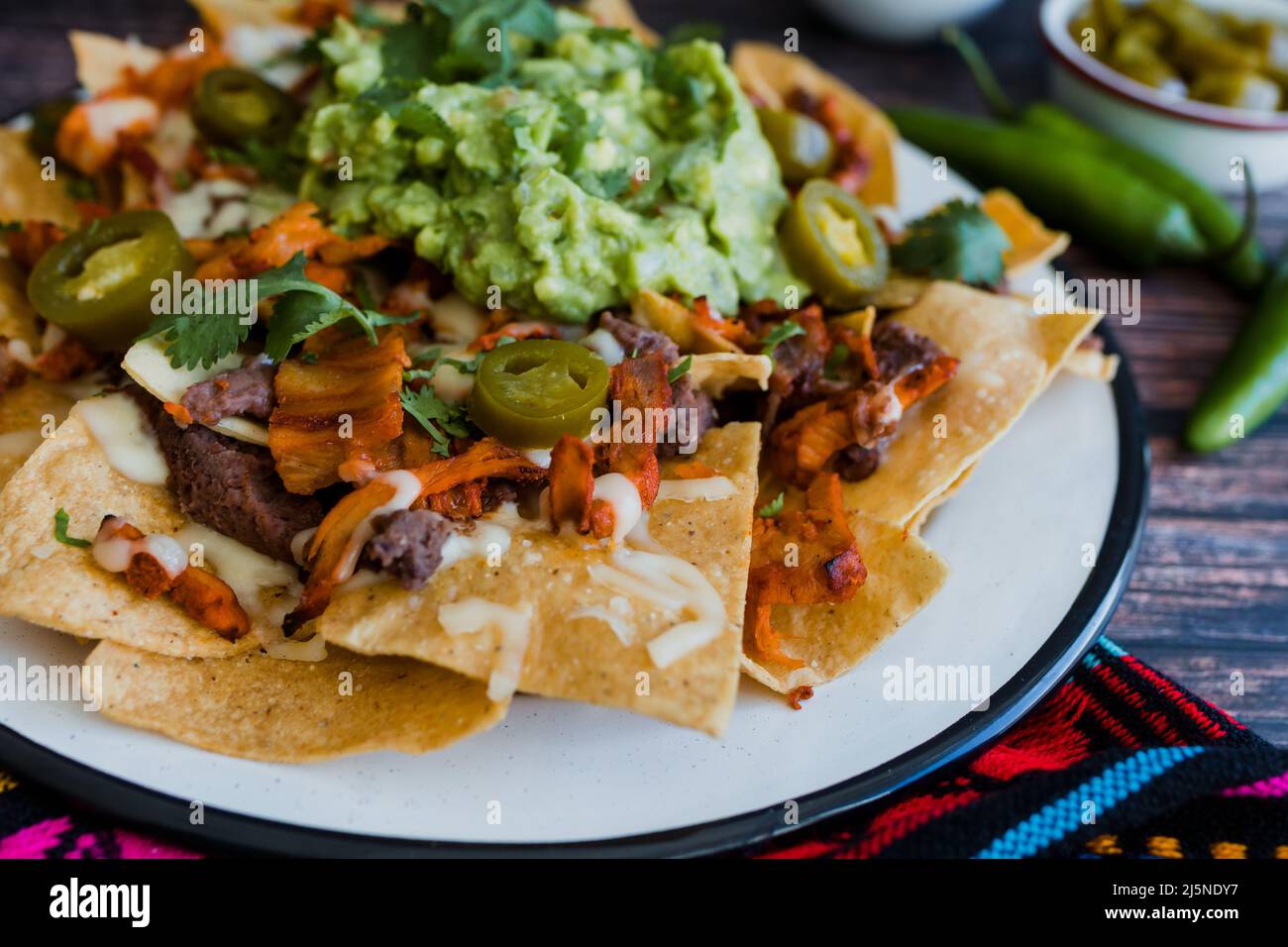 Mexican nachos chips with american cheese and avocado, traditional food in Mexico Latin America Stock Photo