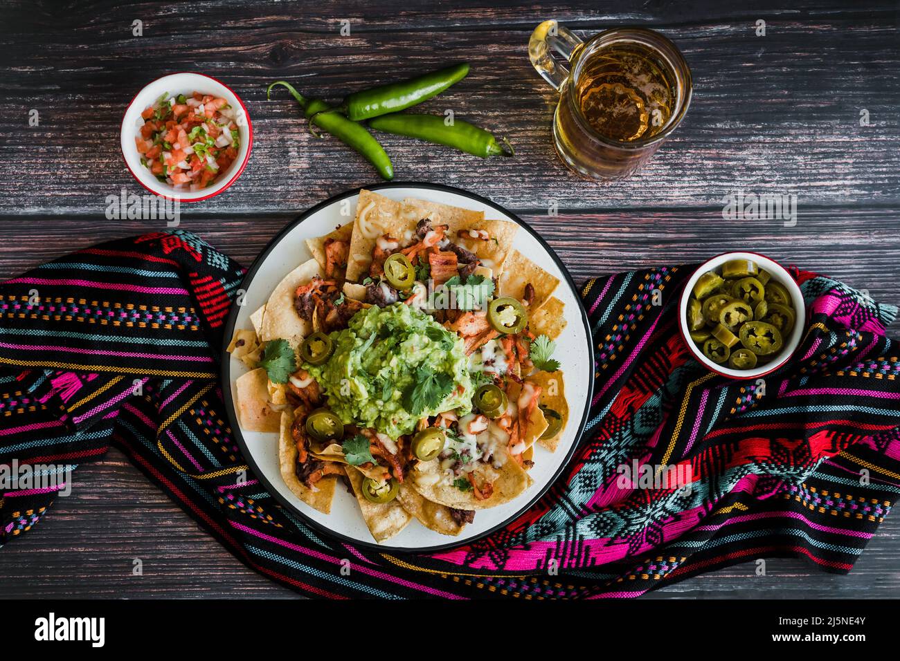 Mexican nachos chips with american cheese and avocado, traditional food