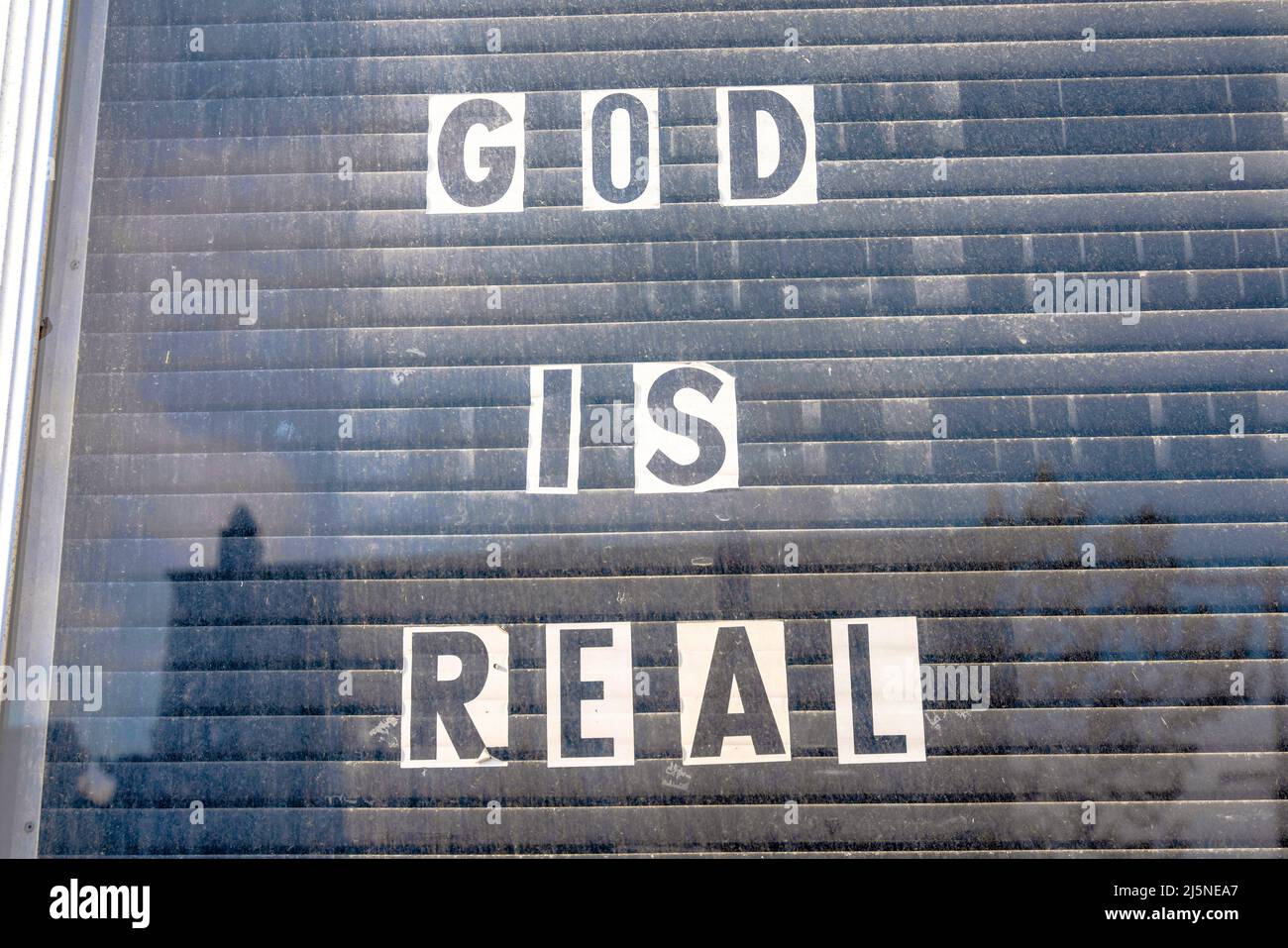 Glass window with God is real letterings on a white paper at San Francisco, California Stock Photo