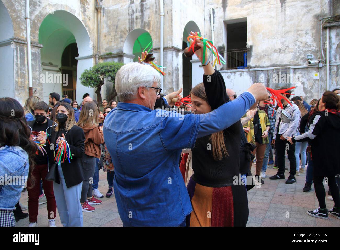 April 24, 2022, Pagani, Campania/Salerno, Italy: Men and women, young and old, seen for the old town dance the ''Tammurriata'' on the day of the feast of Santa Maria Incoronata del Carmine called ''Madonna delle Galline''. The most important feature that surrounds the entire festival is the tammurriata, a frenzied popular music that breaks out on Friday in albis, accompanies the population for the entire day of Sunday and ends at dawn on the following Monday, when the people of the devotees go to lay at the feet of Our Lady the tammorras used during the feast. The tammorra is a frame drum th Stock Photo