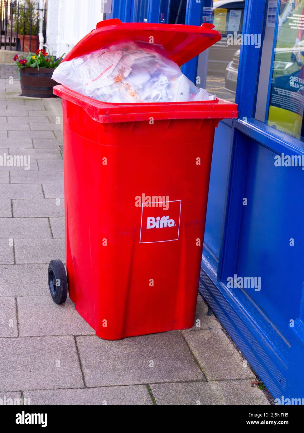 Red Biffa wheelie bin for disposal of waste paper Stock Photo