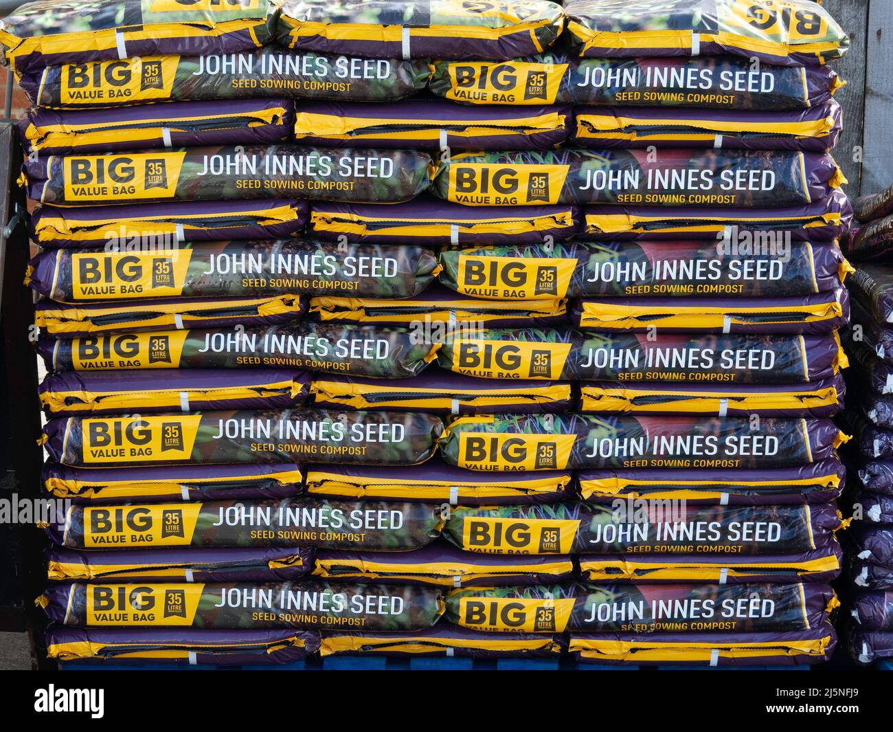 A stack of  35 litre big value bags of John Innes seed sowing compost for sale in a farm shop Stock Photo