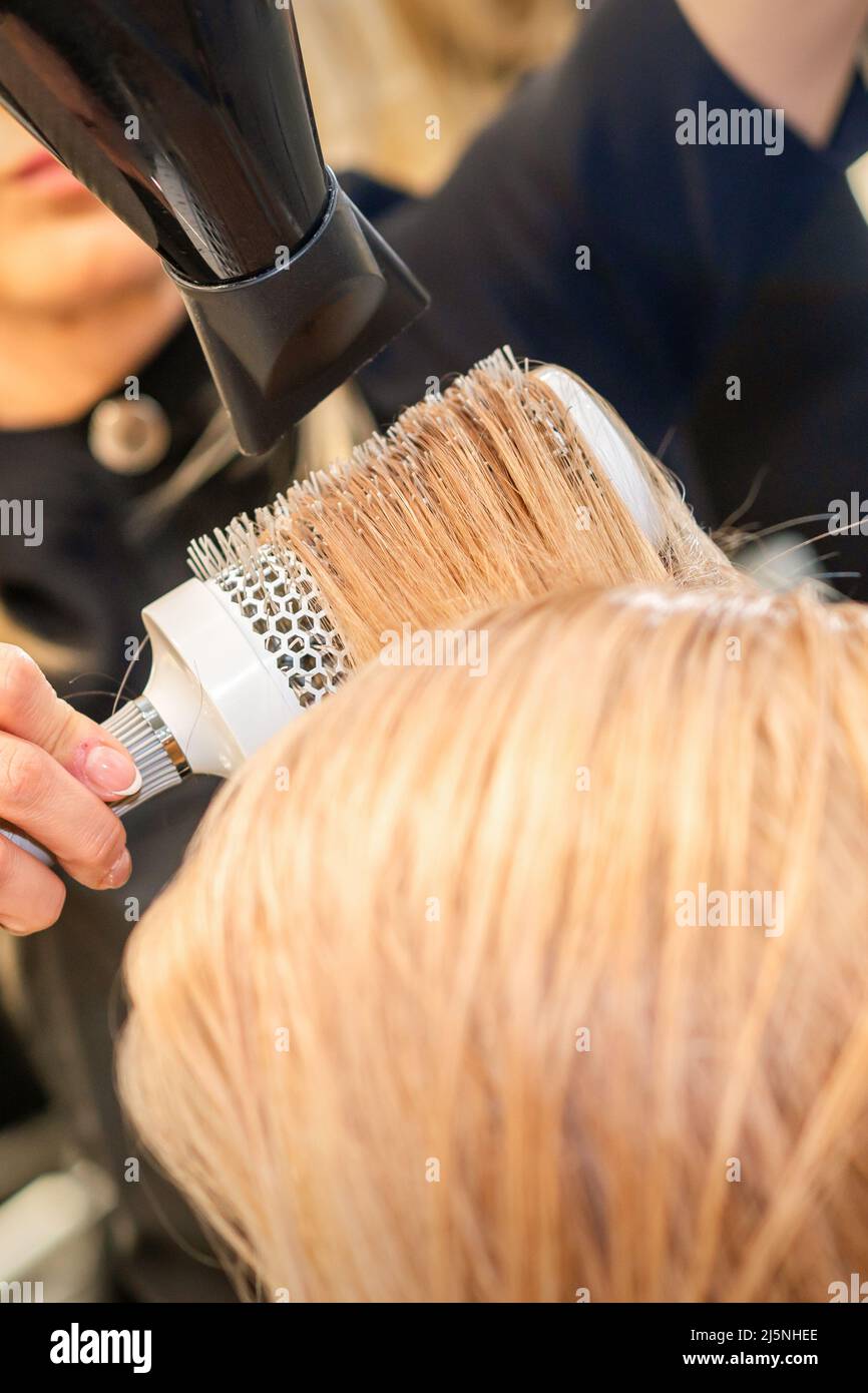 Hair blonde dryer round brush hi-res stock photography and images - Alamy