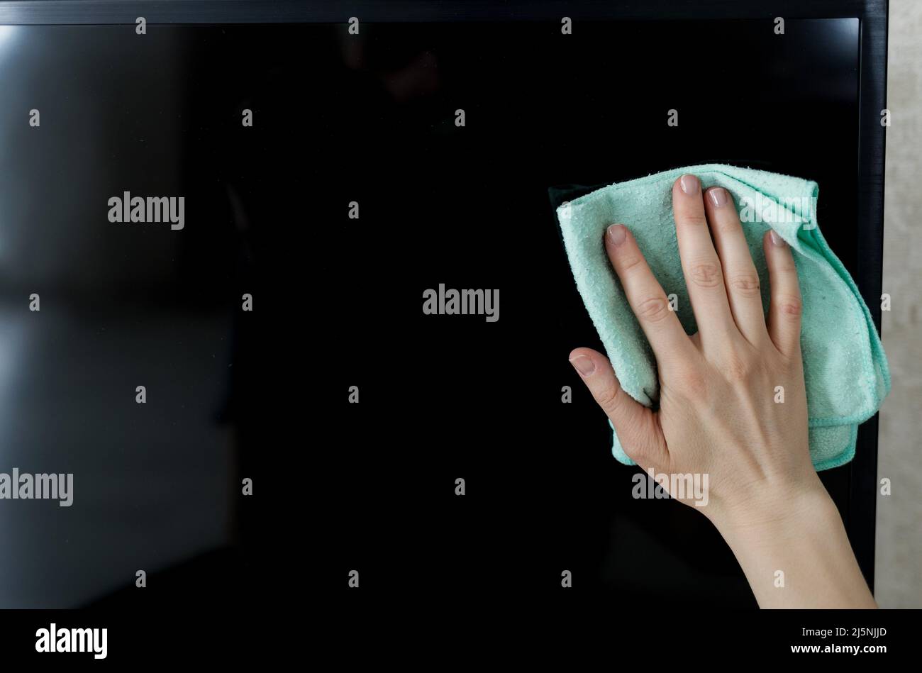 Hand Cleaning Television With Cloth At Home. Cleaning service Stock
