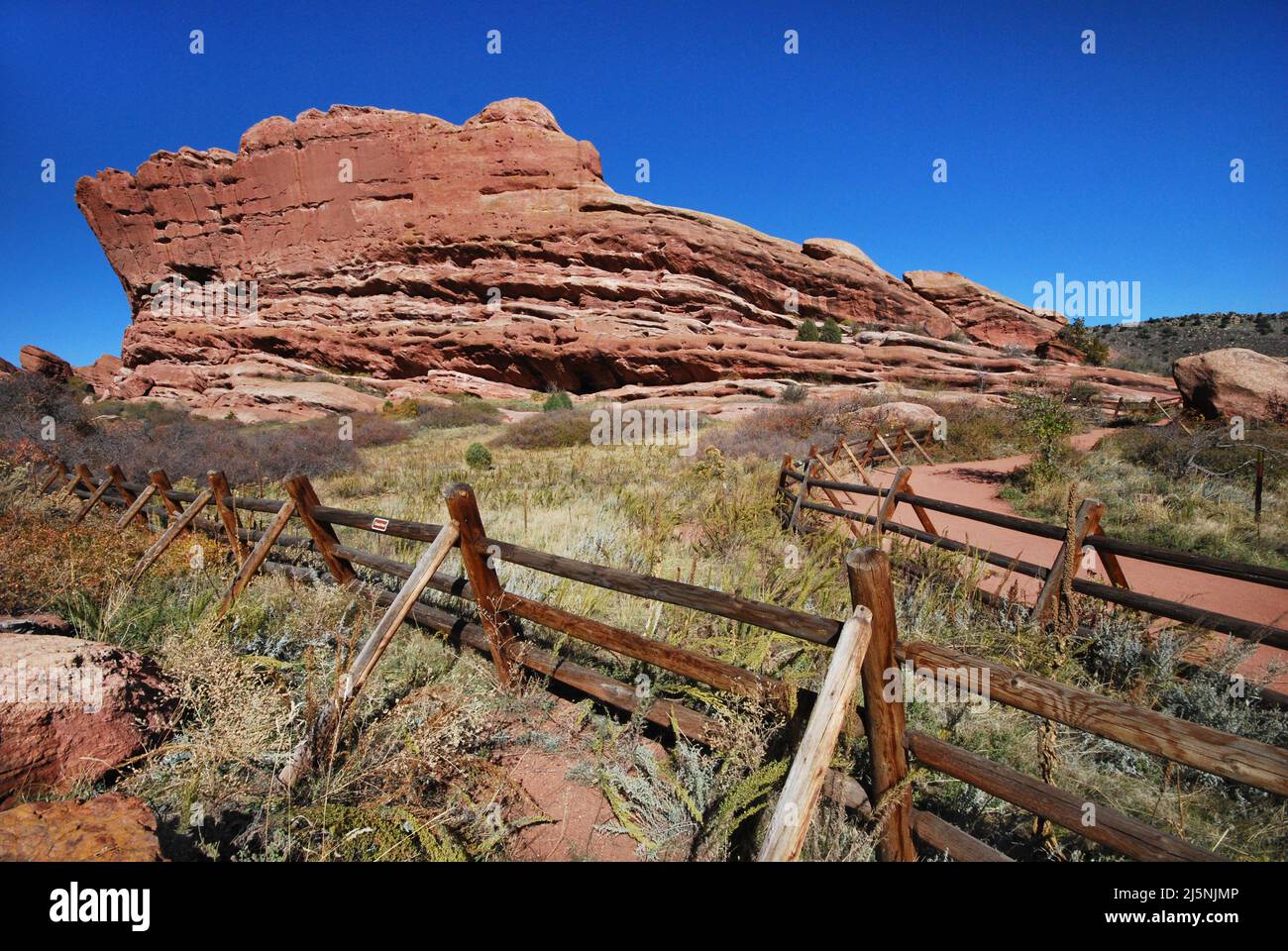 View destroying fences closing off areas and limiting walkways and artistic views at Red Rocks Park in Morrison Colorado Stock Photo