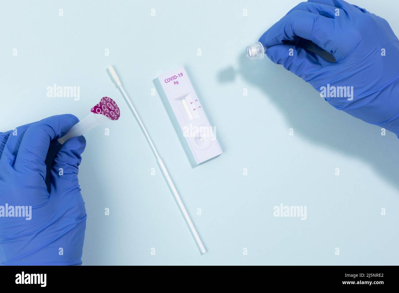 how to use self checking covid test kit, blue background Stock Photo