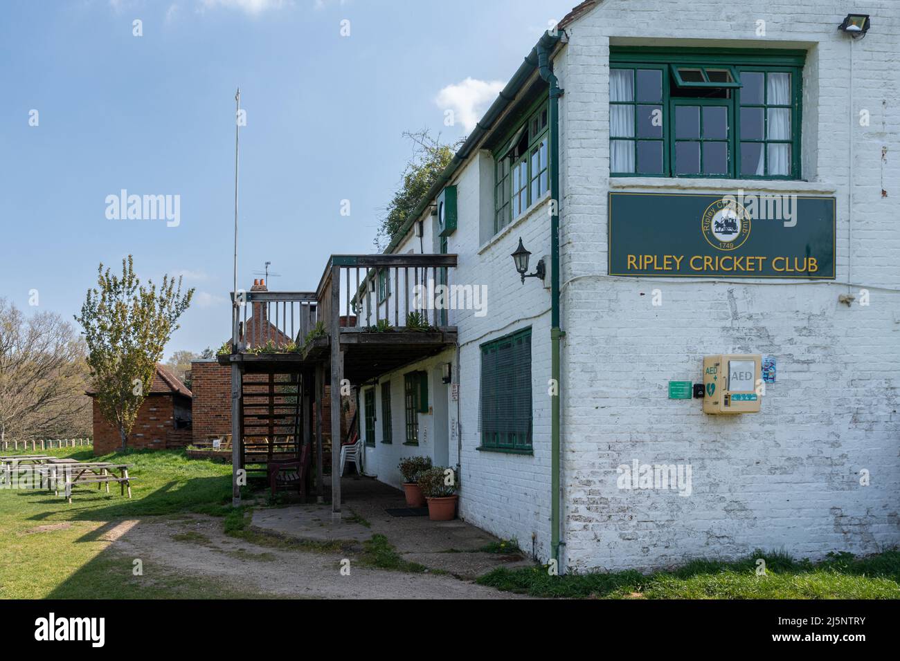 Ripley Cricket Club pavillion building beside cricket pitch, Surrey, England, UK Stock Photo