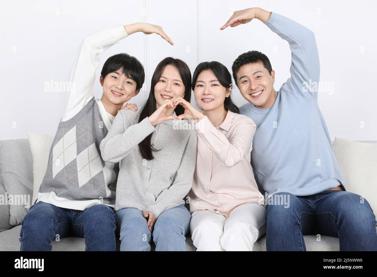 Asian Korean family Family photo sitting side by side and posing for a