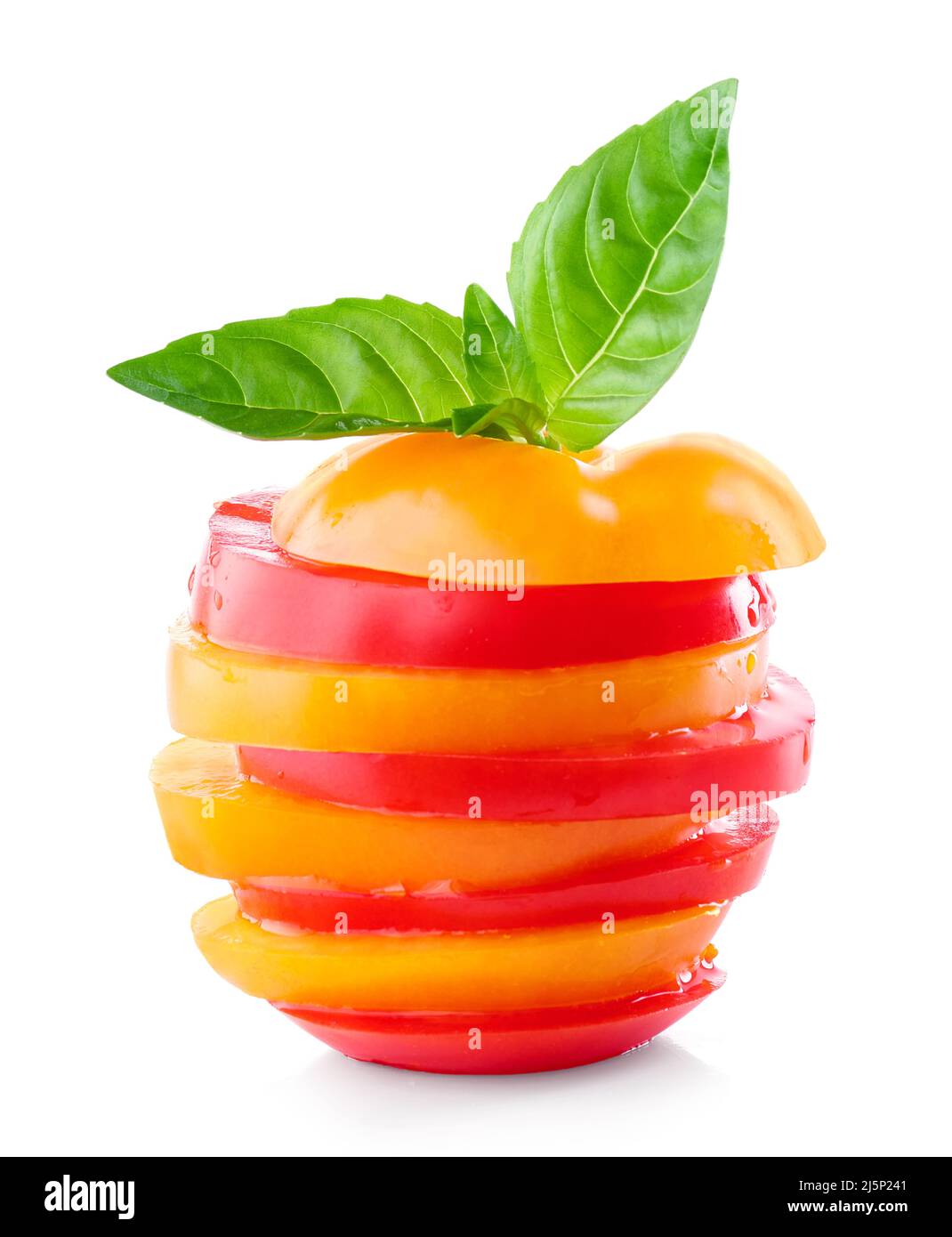 stack of red and yellow tomato slices and green basil leaf isolated on ...