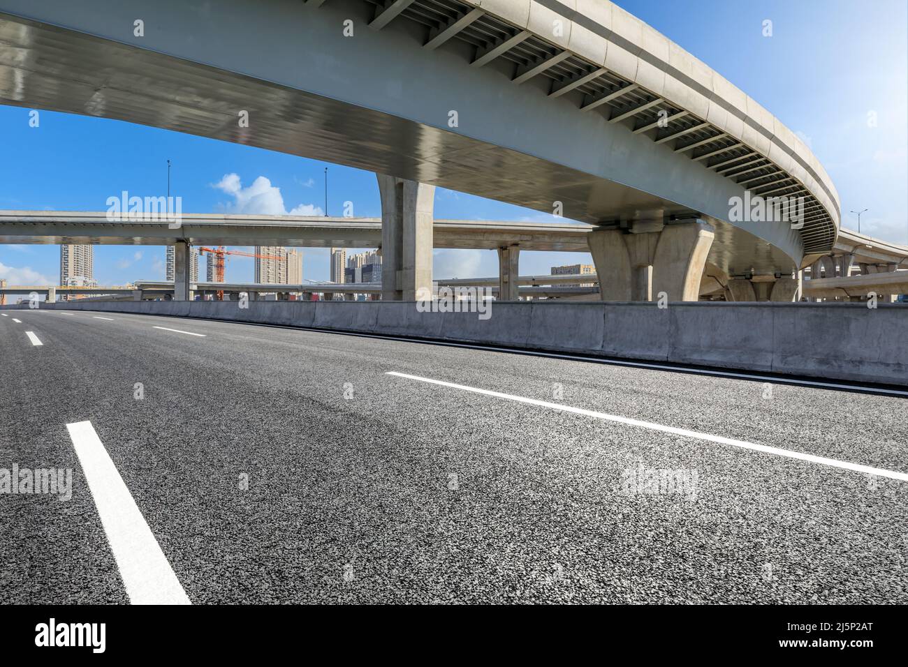 Asphalt highway and bridge under blue sky Stock Photo