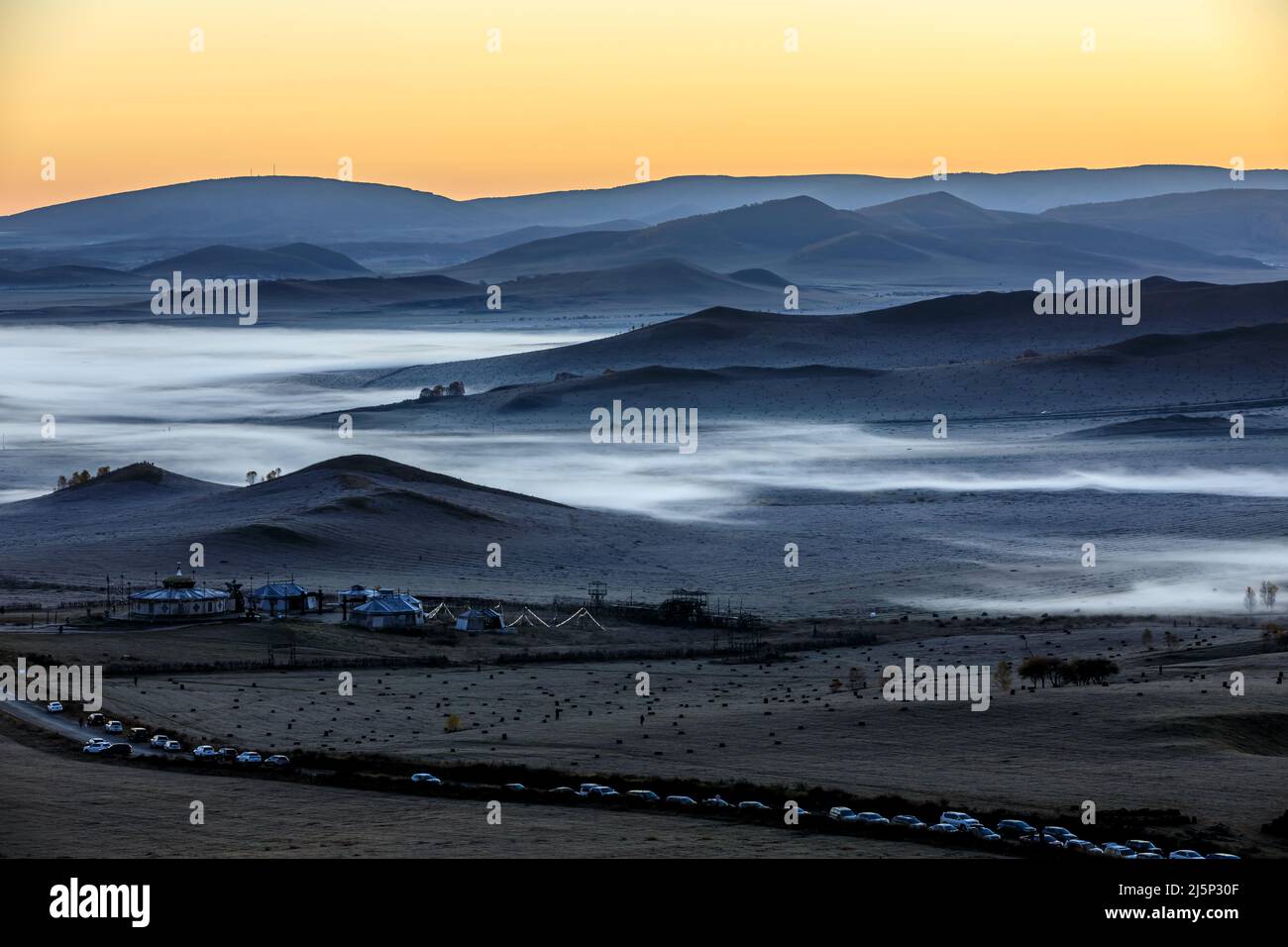 Beautiful natural landscape in Ulan Butong grassland, Inner Mongolia, China. Mountains and clouds nature landscape at sunrise. Stock Photo