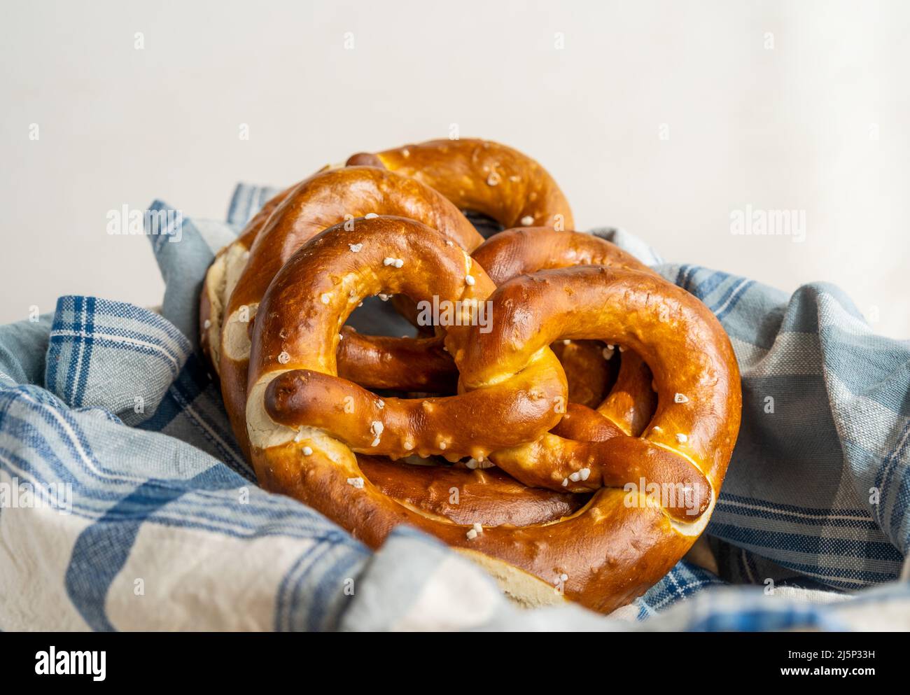 Group of brezels or pretzels in bread basket with napkin  Stock Photo