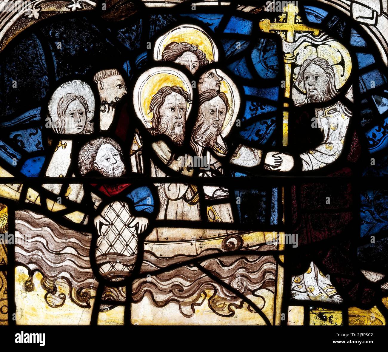 Medieval stained glass depicting Jesus on land and and his disciples in a boat on the sea of Galilee, St Andrew's church, Greystoke, Cumbria, UK Stock Photo