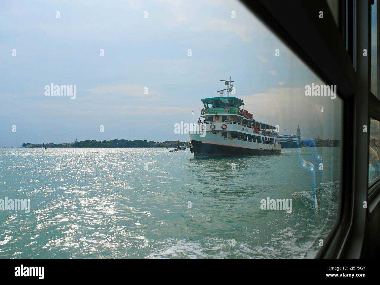 vaporetto (water bus) seen through a window of a motor boat, Venice, Italy Stock Photo