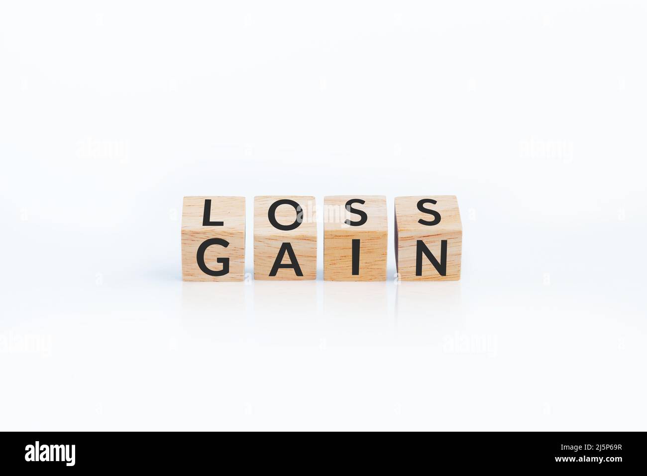 turn loss into gain concept, wooden cube with word LOSS flip to GAIN. capital investment gain and loss, financial while managing assets e.g. bond Stock Photo