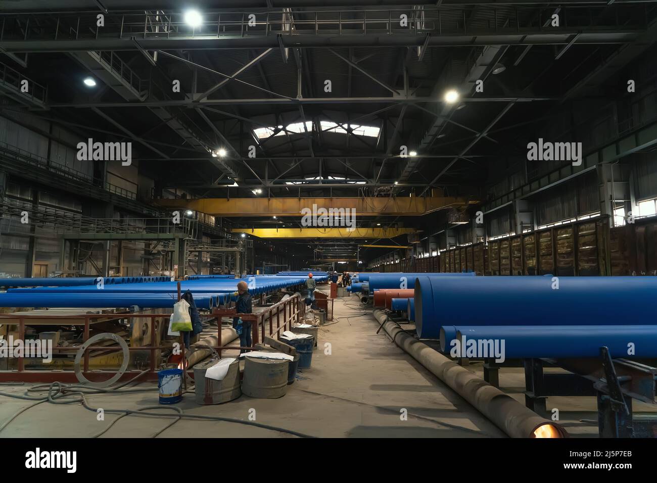 Large workshop for painting metal pipes at metallurgical plant. Stock Photo