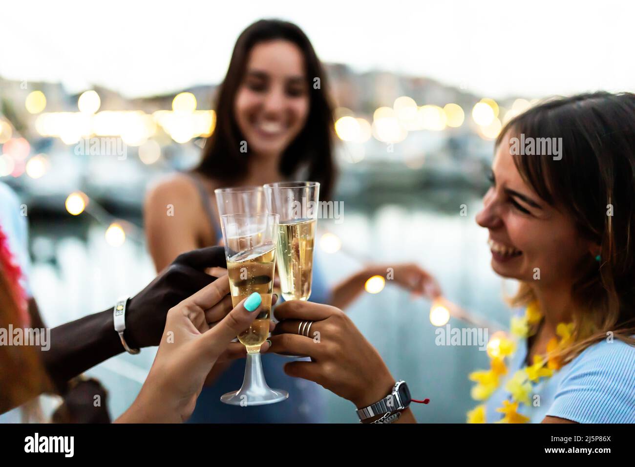 Summer lifestyle concept with young multiracial people cheering on boat party Stock Photo