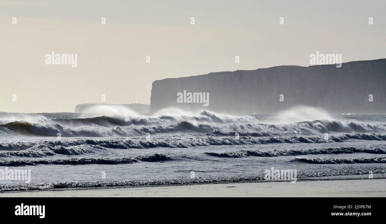 Big waves at Filey Bay, with Bempton Cliffs behind, Yorkshire east coast, northern England, UK Stock Photo