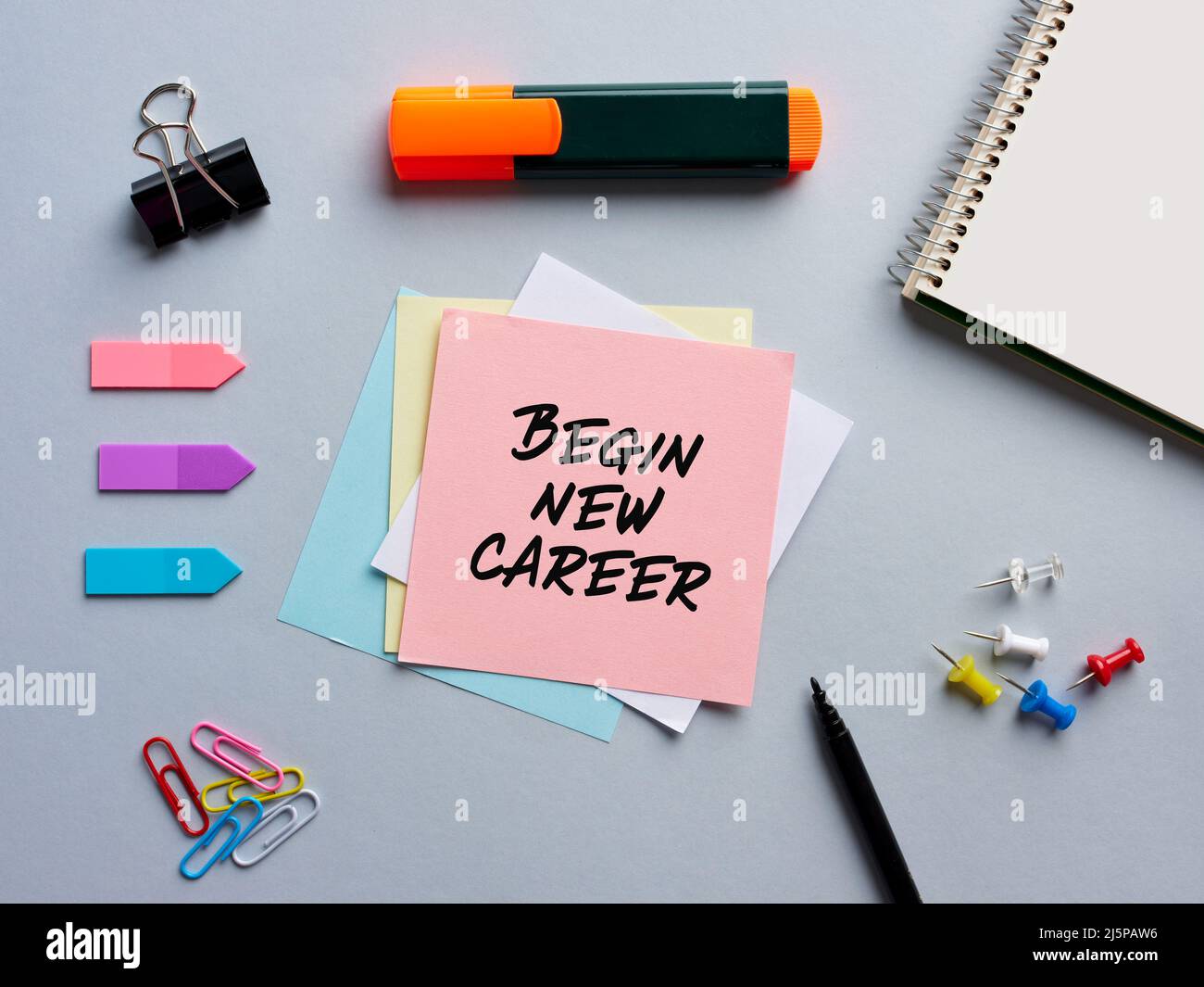 The note begin new career written on a notepaper on office desktop. Business career new beginning concept. Stock Photo