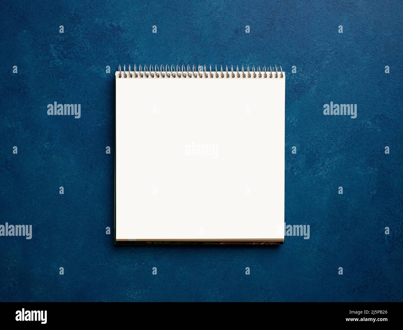 Blank or empty notebook on blue business office desktop. Stock Photo