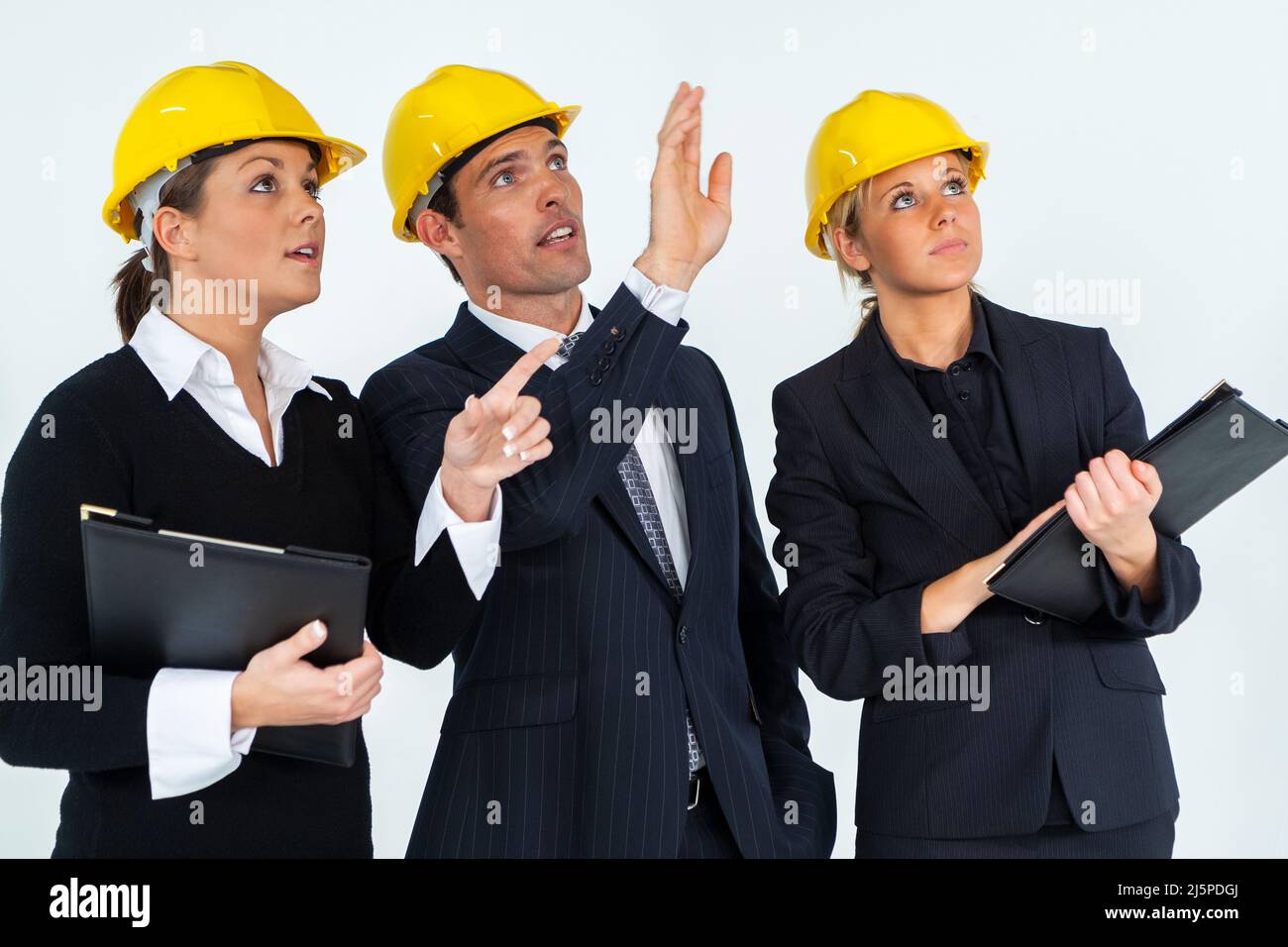 Construction workers, building site team, wearing hard hats on white background Stock Photo