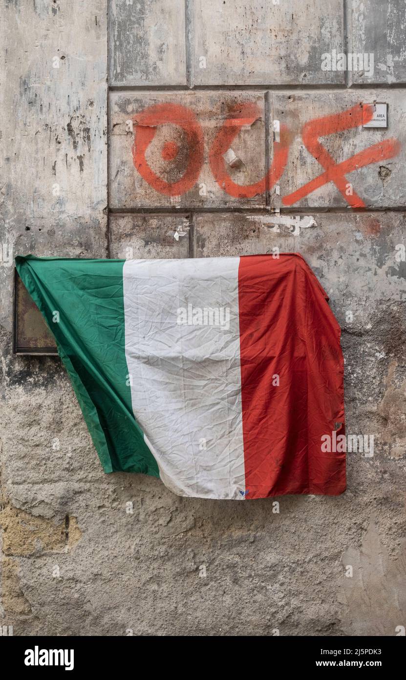 Old Italian flag draped on wall in Naples Italy Stock Photo