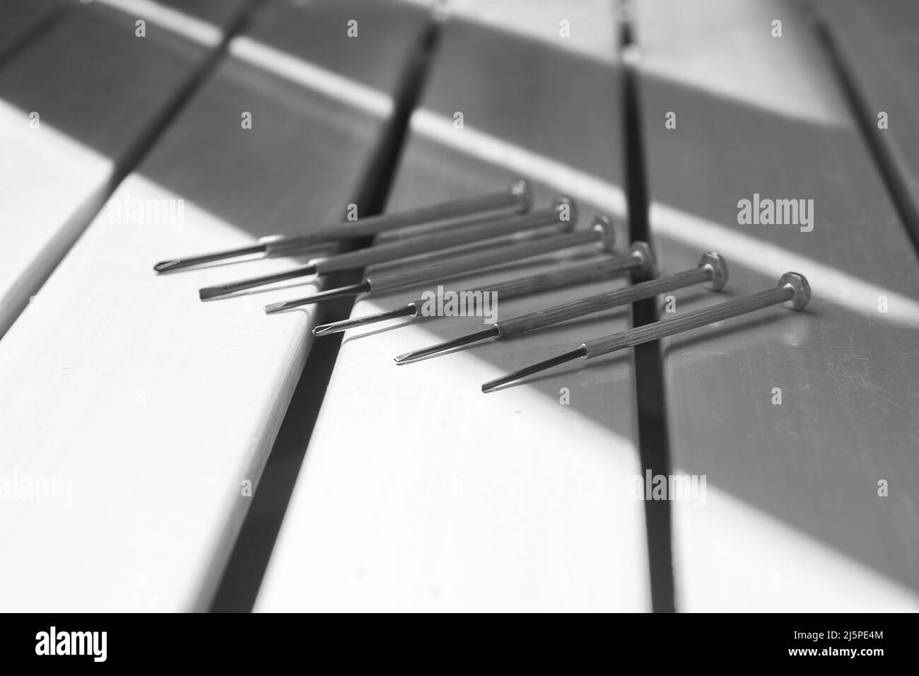 Repair set of metal screwdrivers on a black and white background Stock Photo