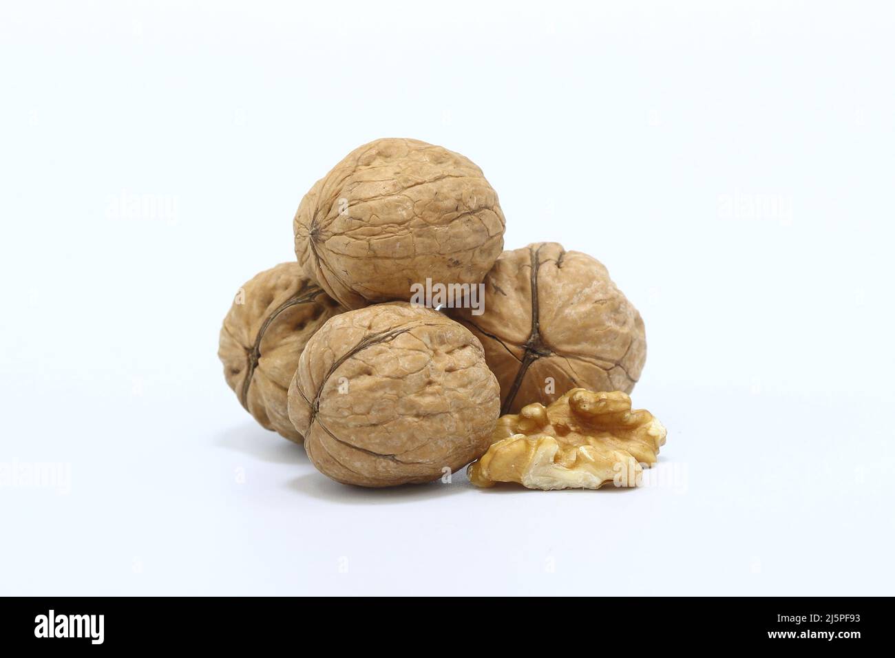 whole walnuts and walnut kernel isolated on white background. Stock Photo