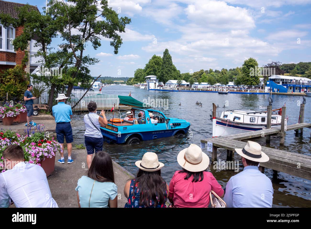 Spectators watch a Dutton Surf amphibious car driving into the River ...
