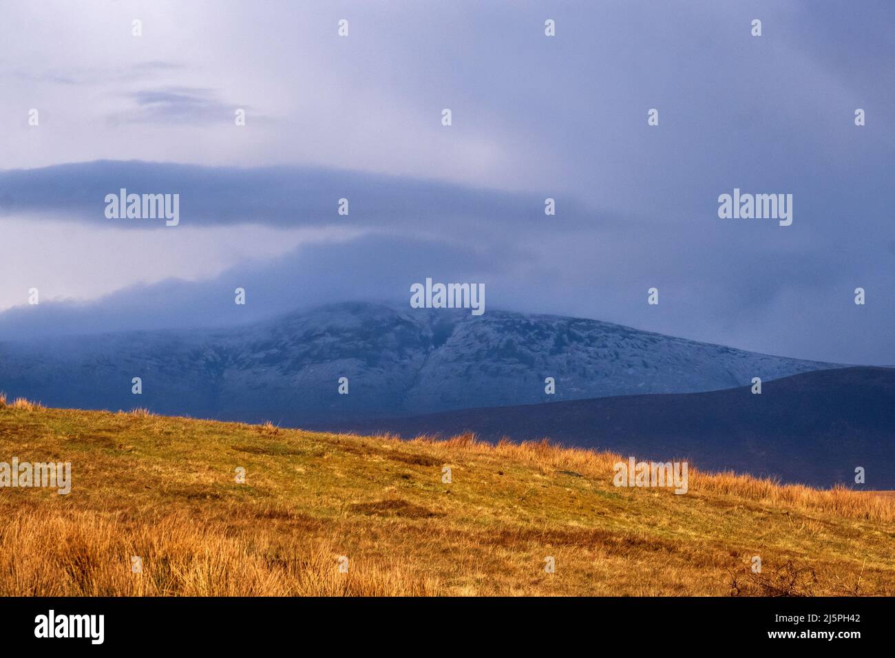 Snow-covered peak in Ballycroy National Park, seen from Achill Island, Ireland Stock Photo