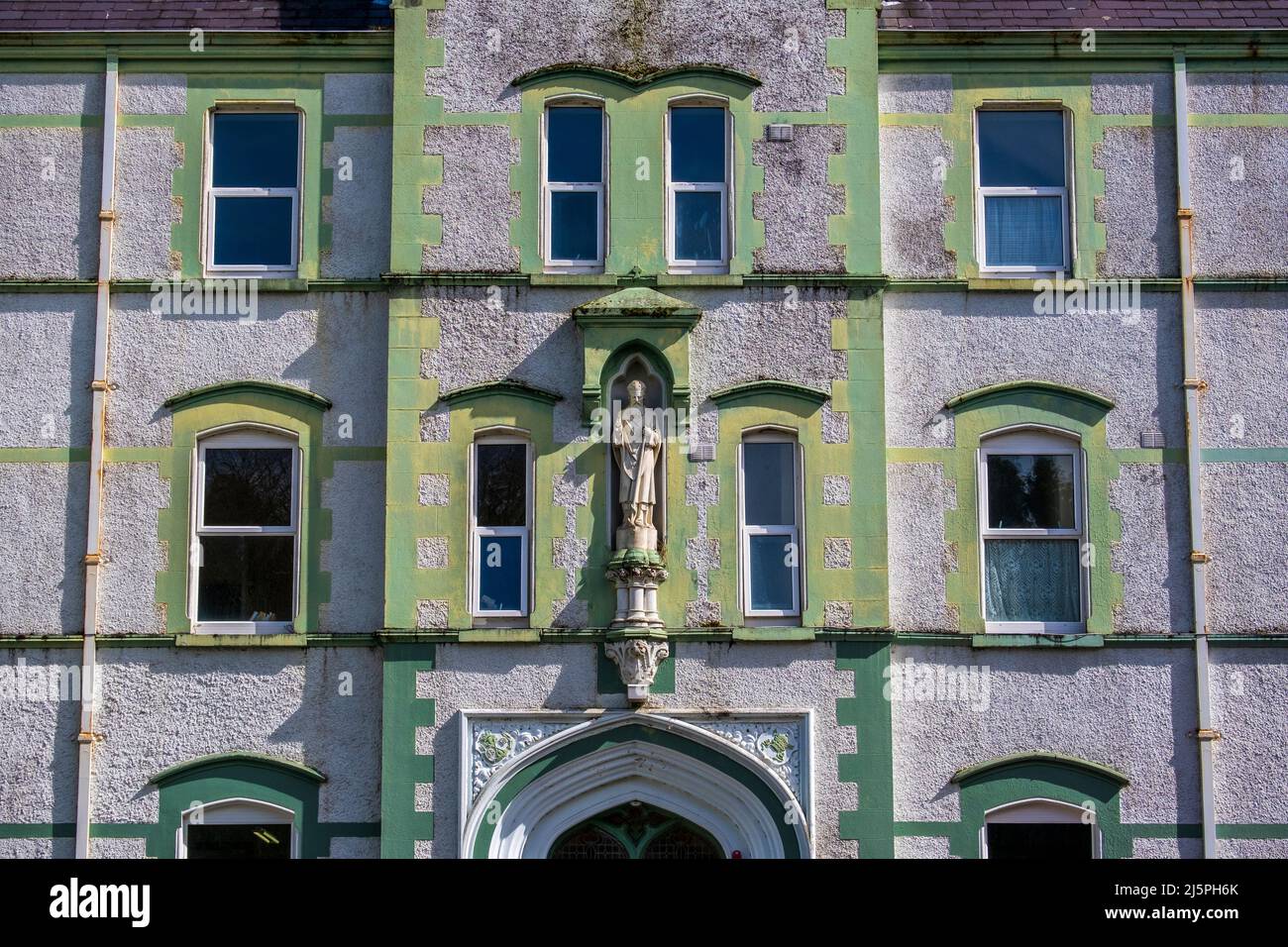 Green facade of the church at Esker Monastery, County Galway, Ireland Stock Photo