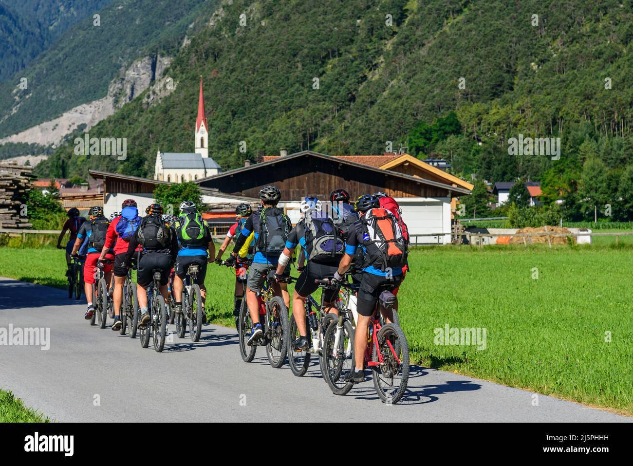 Mountainbikers cycling in Inn valley between Imst and Landeck Stock Photo