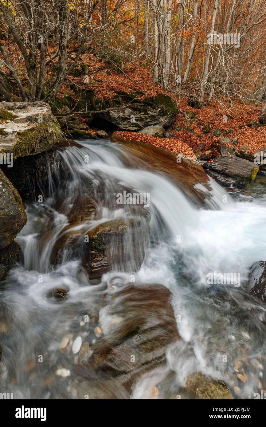 Small waterfall in autumn, Aure valley, Pyrenees, France Stock Photo