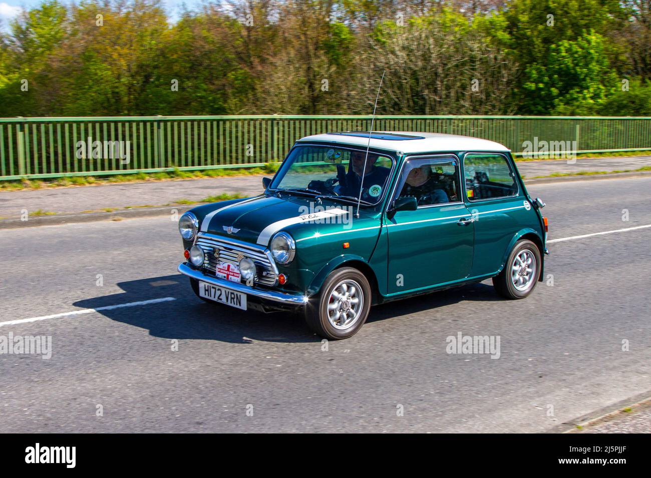 1990 90s nineties green Rover Mini Cooper 1 1275cc petrol 4 speed manual 2dr small car; crossing motorway bridge in Greater Manchester, UK Stock Photo