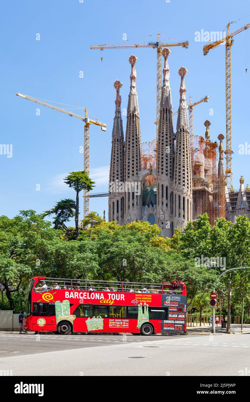 Barcelona, Spain - June 9, 2011: Red tourist hop-on, hop-off bus by The La Sagrada Familia cathedral in Barcelona Stock Photo