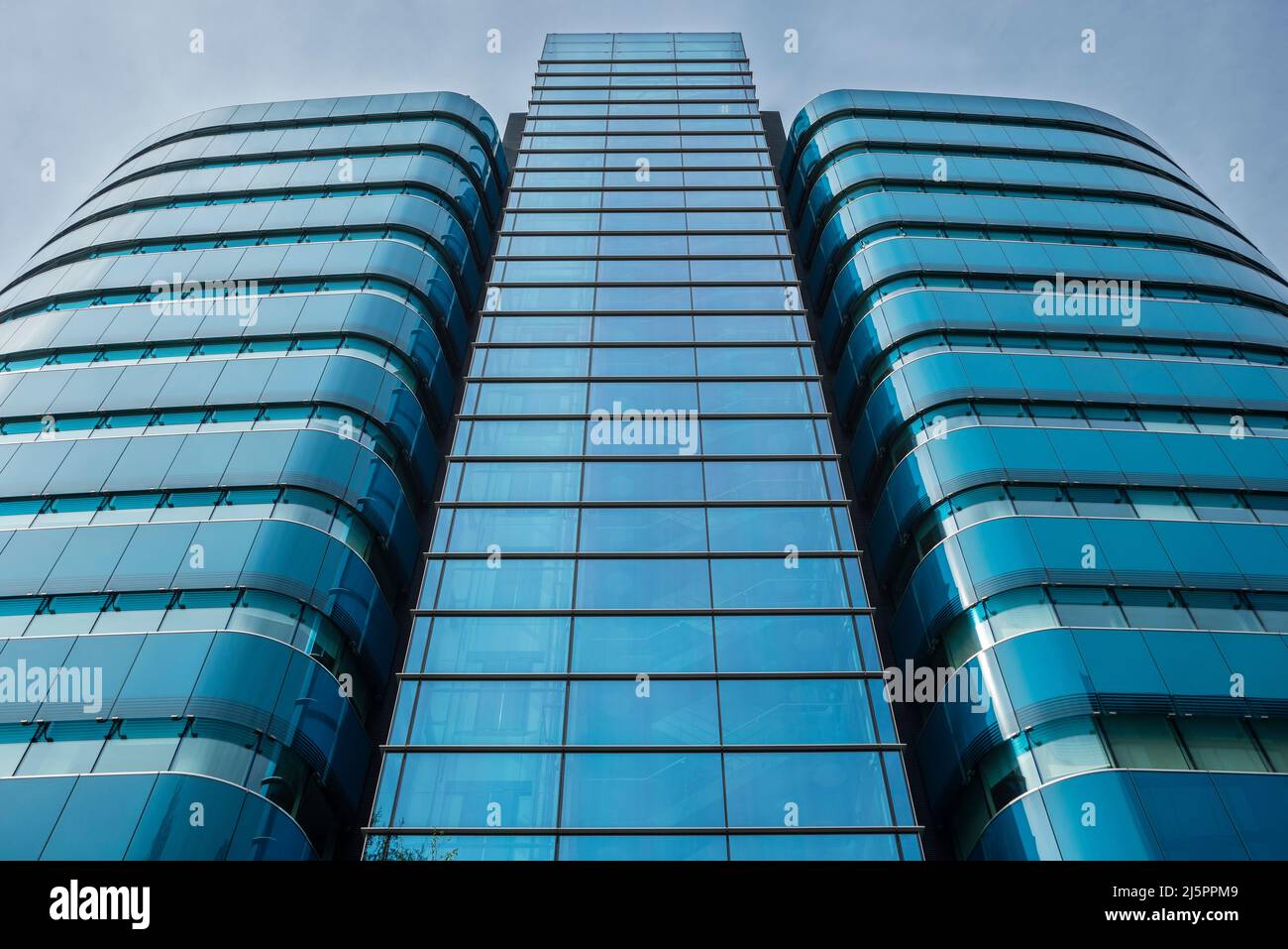 Blue glass clad tower block in a modern business development. Central business district. City of London. Stock Photo