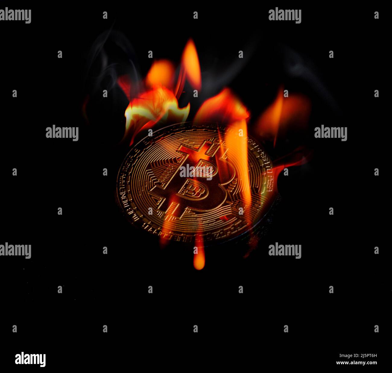 The gold bitcoin is on fire at a black background Stock Photo - Alamy