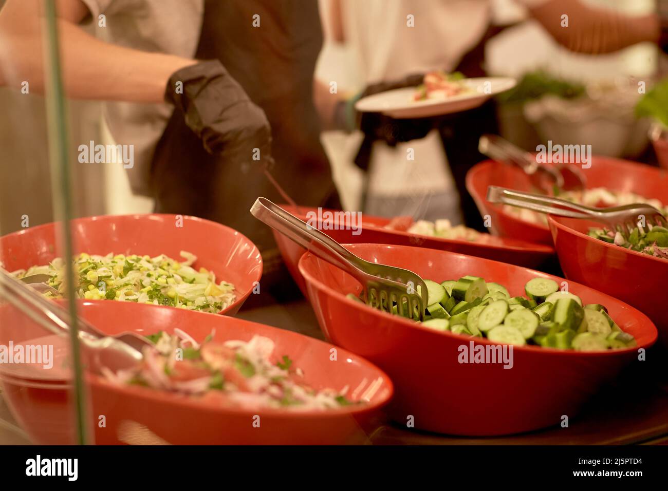 Food distribution, buffet, catering. Person is serving food Stock Photo