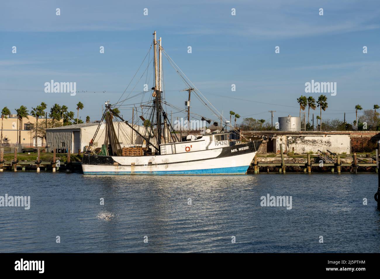 A shrimp boat docked in the Port Isabel Side Channel in Port Isabel, Texas. Stock Photo