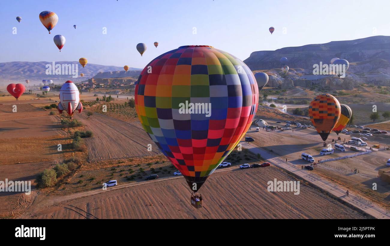 Aerial view of hot air balloons flying at sunrise in Cappadocia, Turkey Stock Photo