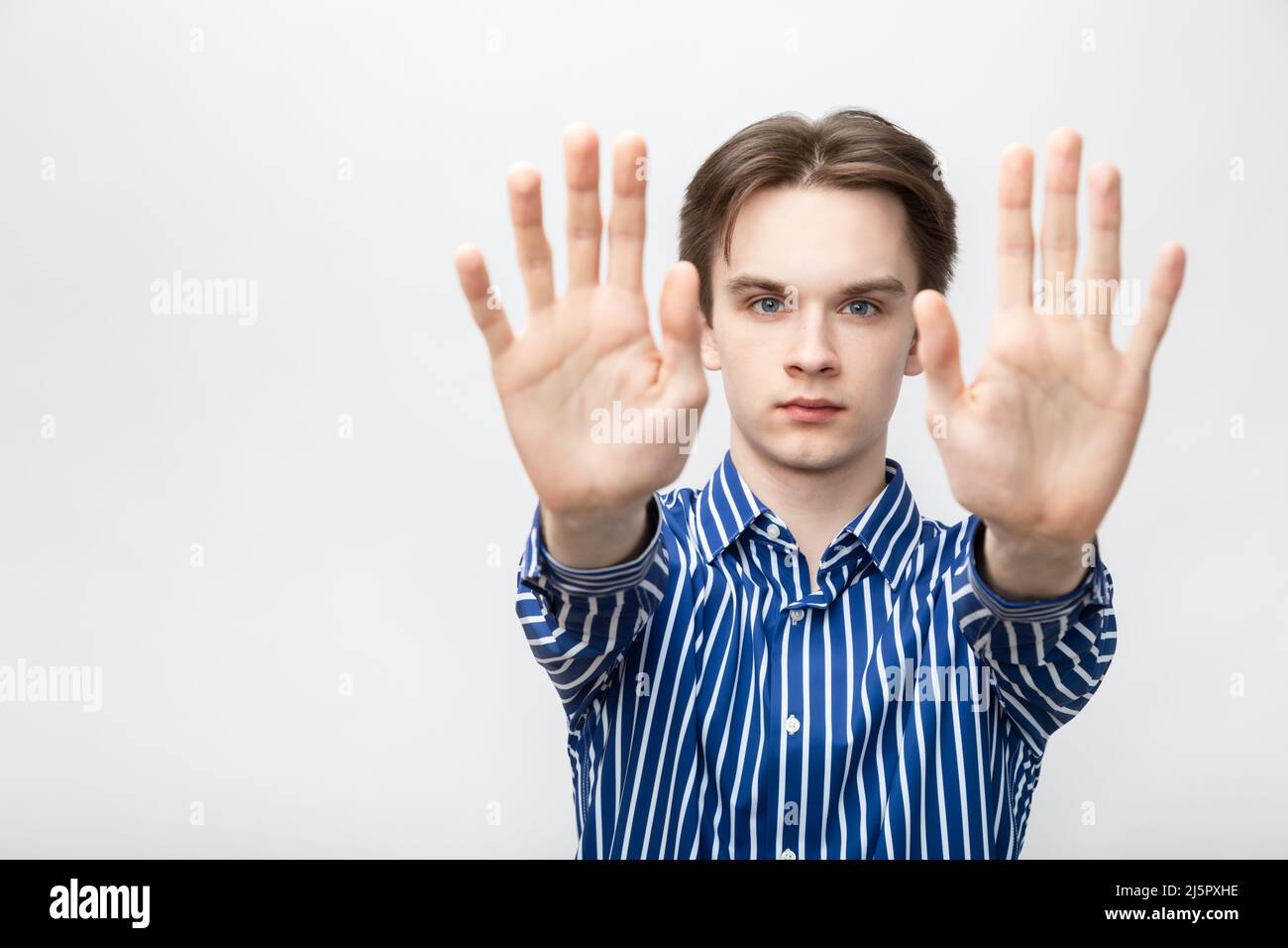 Stop hand gesture. Annoyed young man with hands up Photos