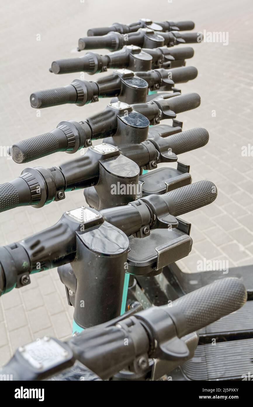 Electric scooter handlebars in a row In Gdynia in Poland Stock Photo