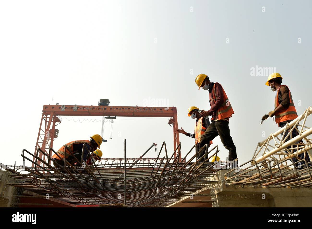 Dhaka. 25th Apr, 2022. Workers tie rebar cages for the First Dhaka Elevated Expressway (FDEE) in Dhaka, Bangladesh, March 17, 2022. TO GO WITH 'Feature: Fast and safe, Sino-Bangladeshi expressway joint venture sees clear road ahead' Credit: Xinhua/Alamy Live News Stock Photo